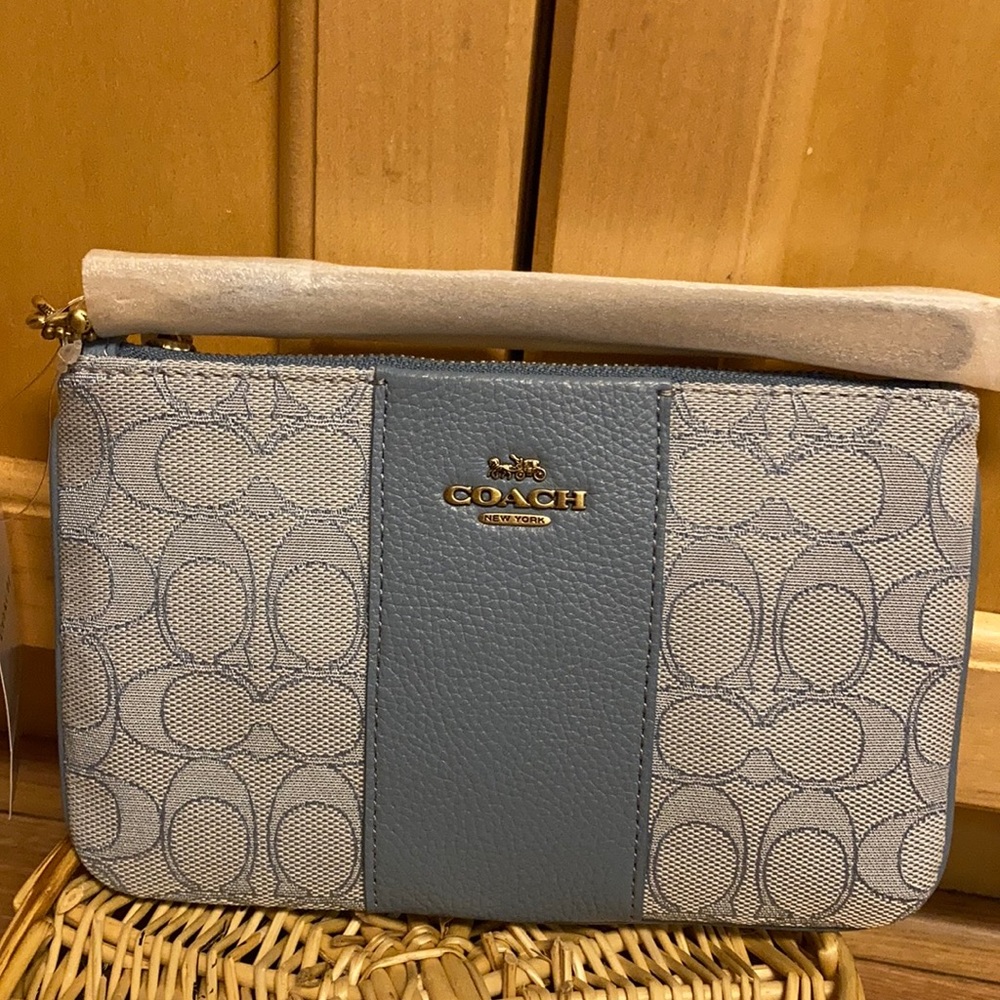 Coach brass/marble blue azure wristlet.